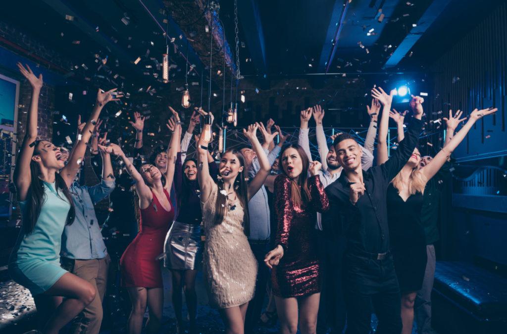 Portrait of good-looking festive lady guy having fun raise hands arms shout laugh, emotional have vent holidays free time rejoice suit dress discotheque